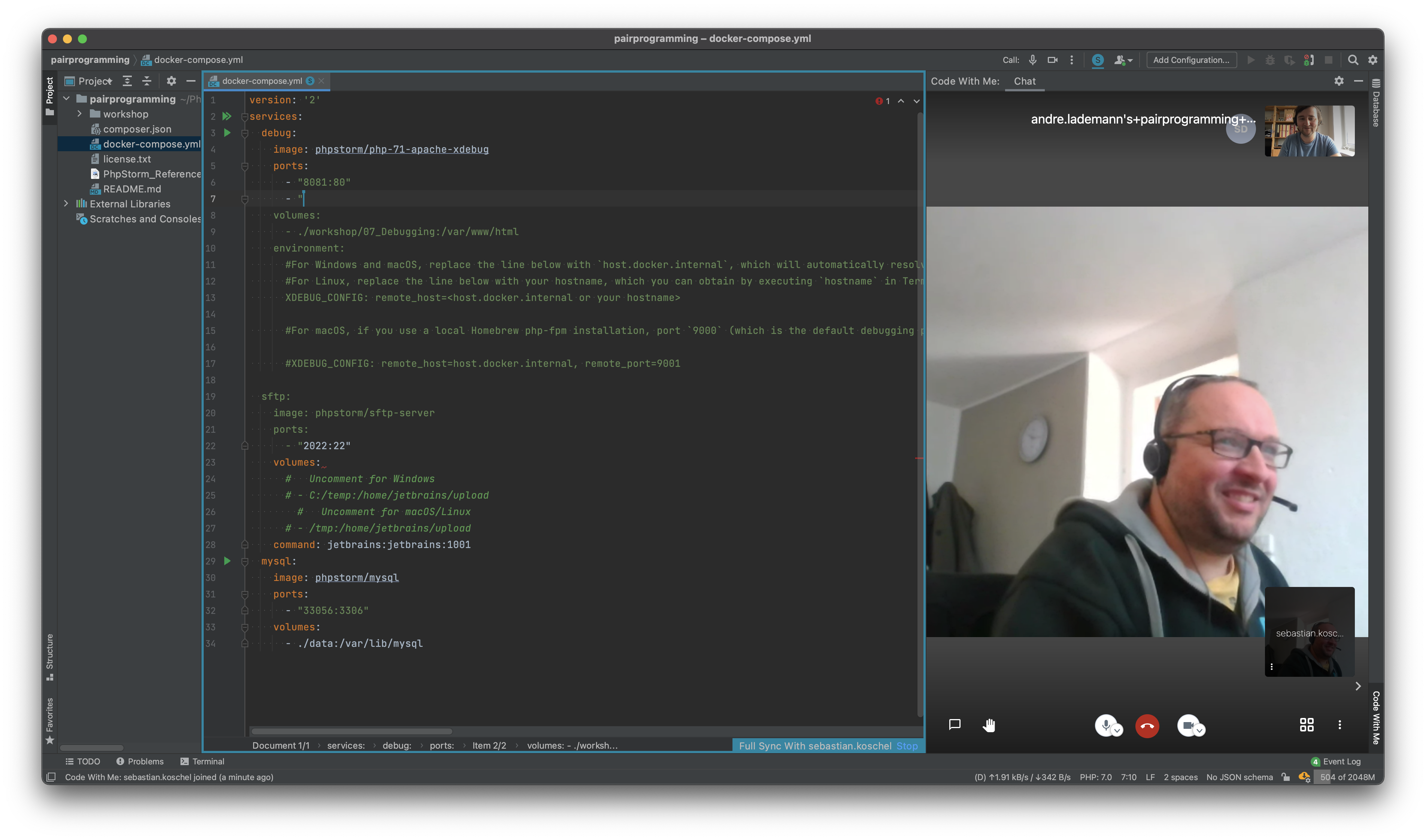 JetBrains IDE during a Code With Me pair programming session with docker-compose.yml open and video chat